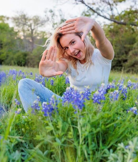 a woman in a field of bluebonnets at The Hudson